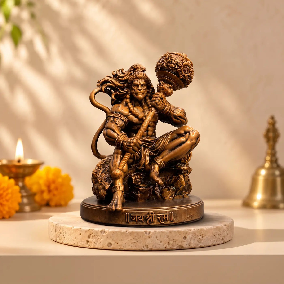 Mahabali Hanuman murti in a home mandir beside a diya and marigolds