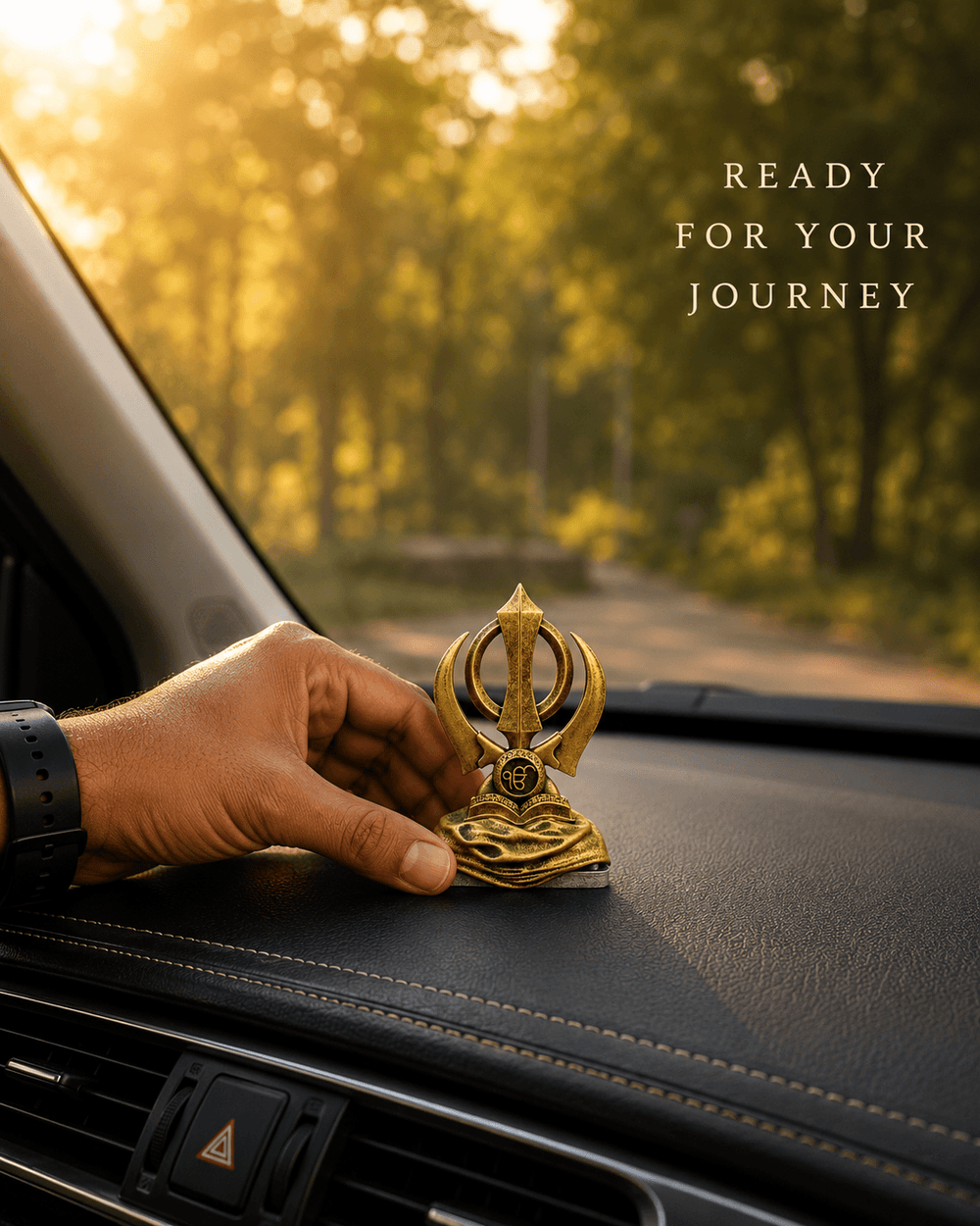 A hand placing the Khanda Sahib piece on a car dashboard