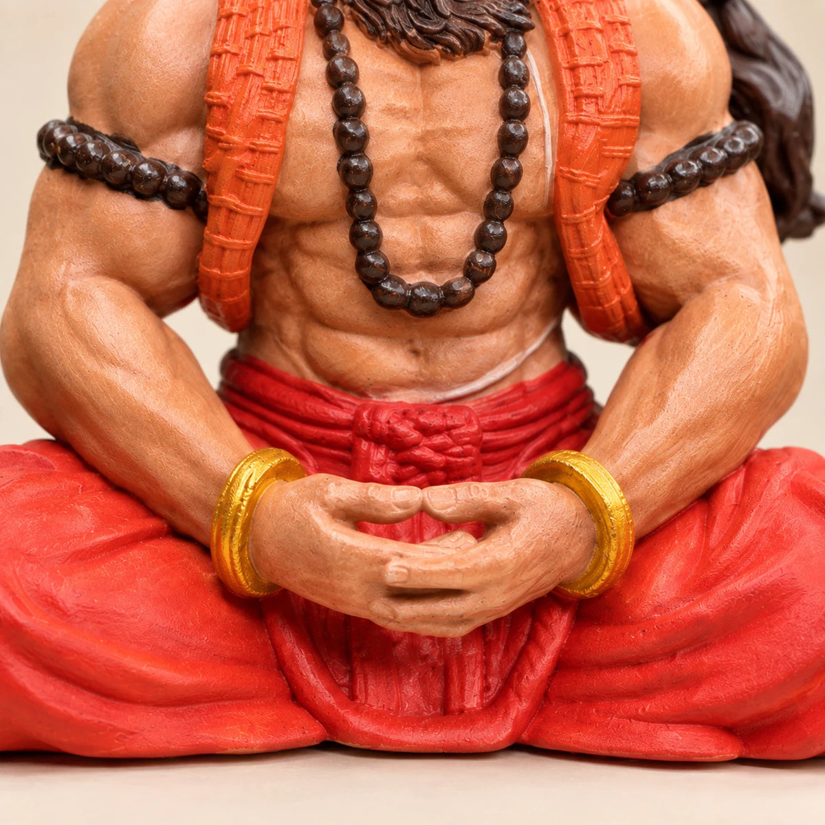Close-up of Hanuman Ji's hands resting in dhyan, with rudraksha mala and gold kadas