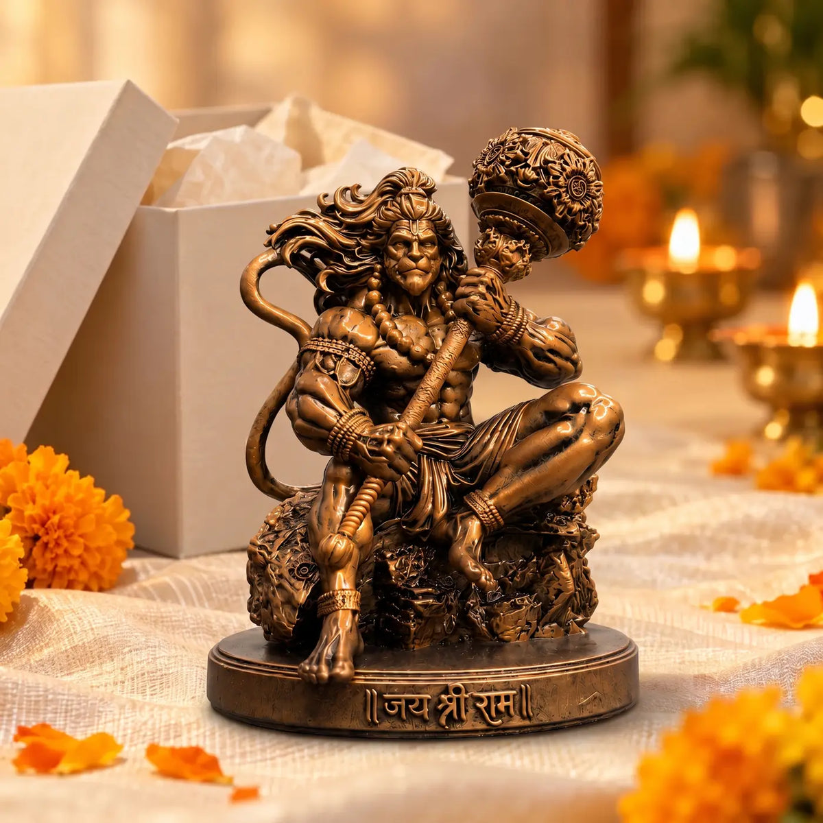 Mahabali Hanuman idol as a gift, beside a gift box and diyas
