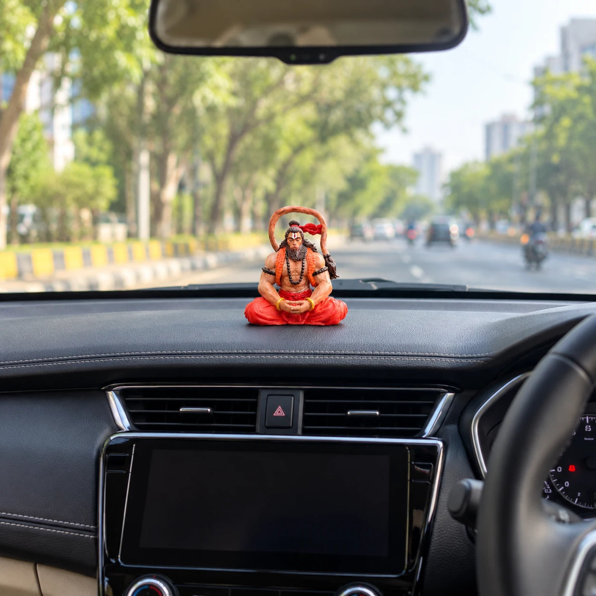 Hanuman Ji car dashboard idol seen from the driver's seat