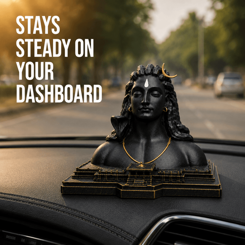 The Aadiyogi bust on a car dashboard