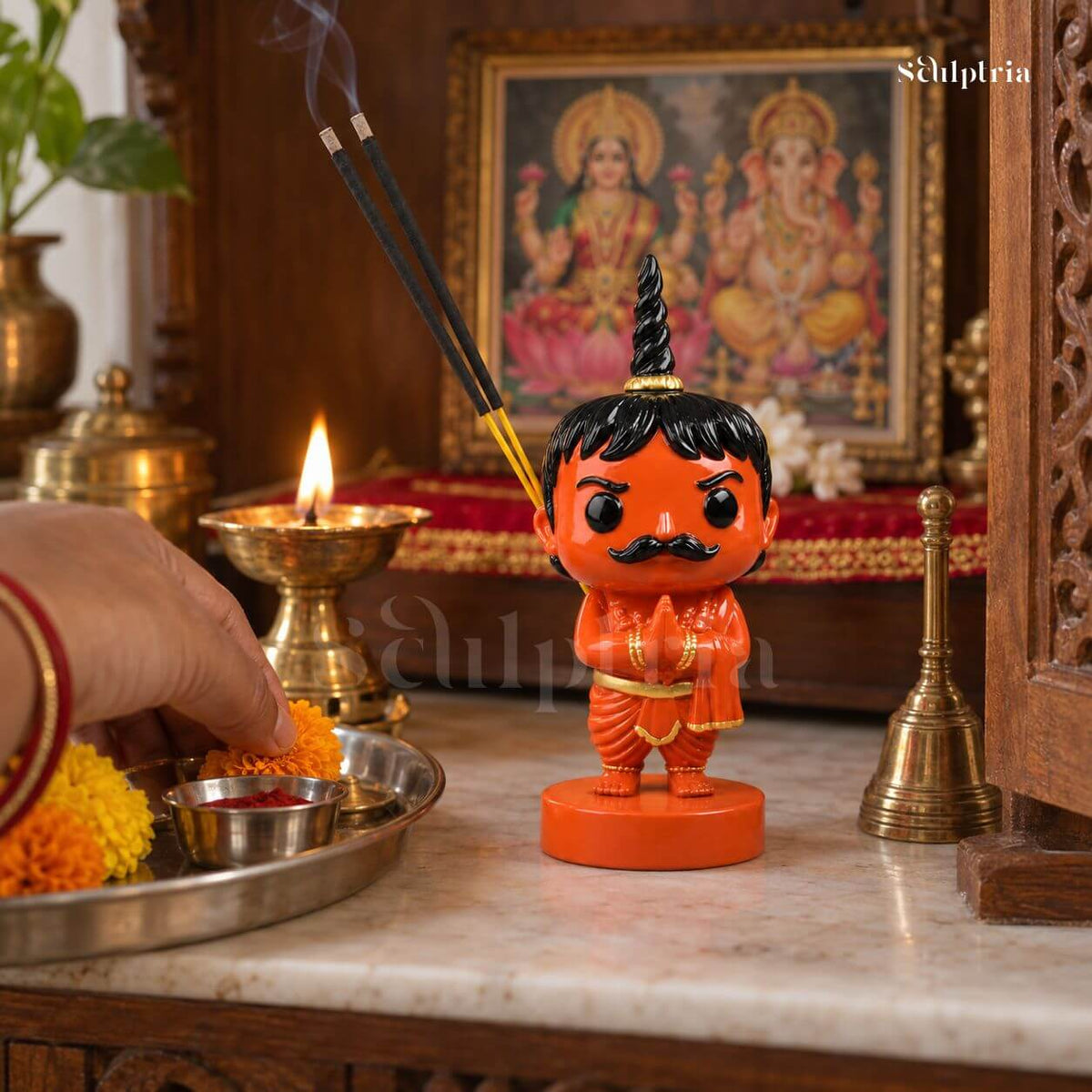 Chota Pandit Ji standing beside a diya in a home mandir