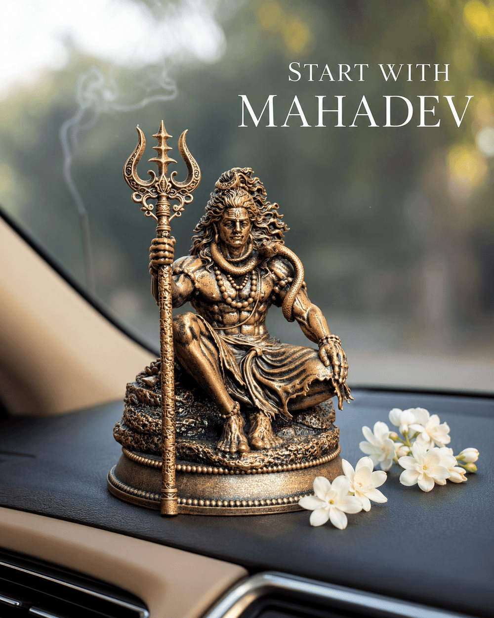 The Mahadev idol on a dashboard beside white flowers
