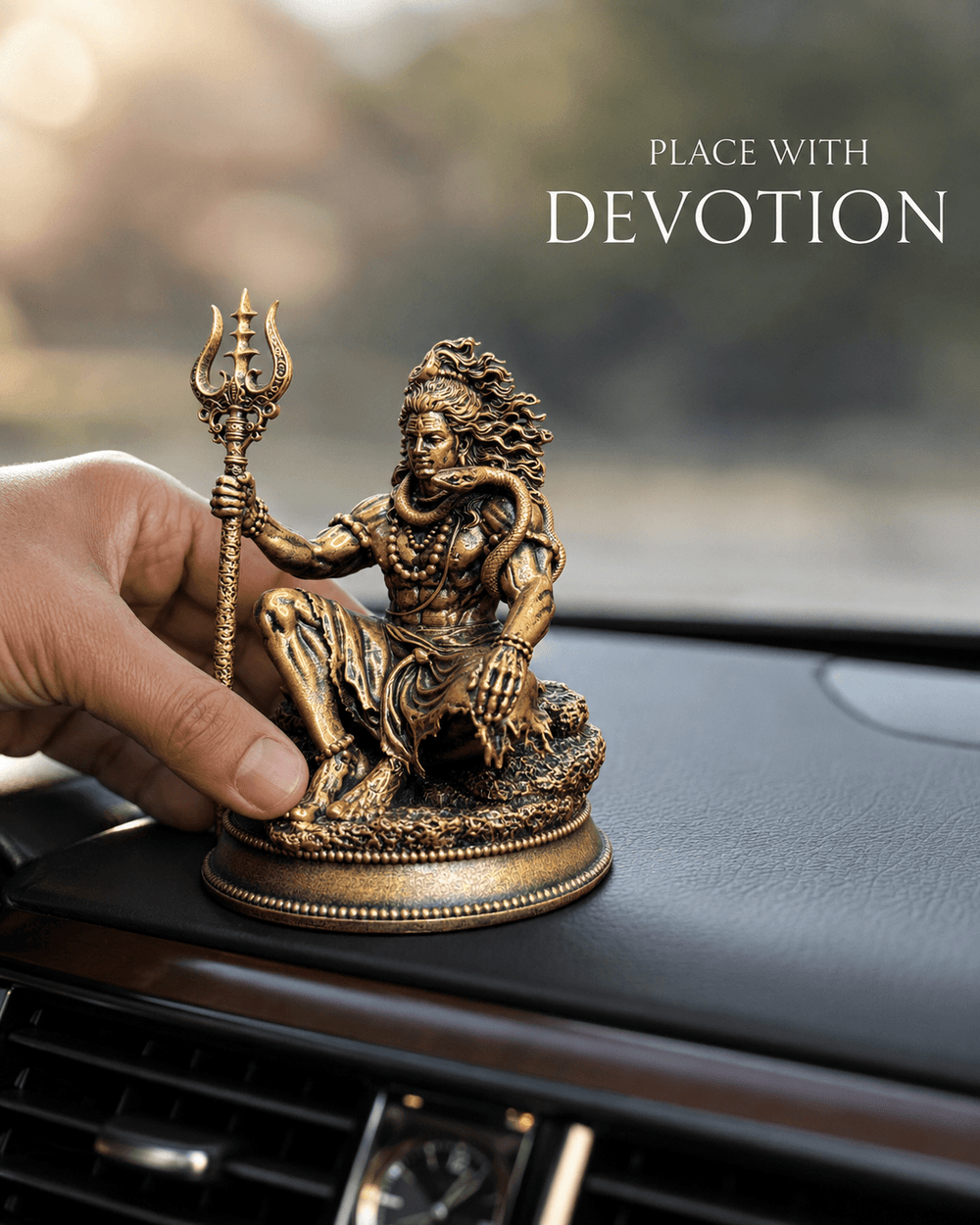 A hand setting the idol down on a dashboard