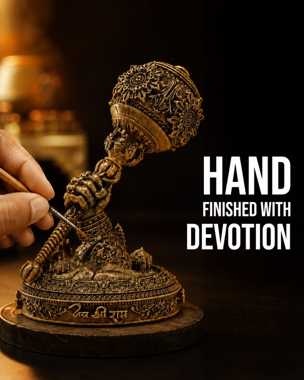 A brush touching up the detail on the Hanuman Gada idol