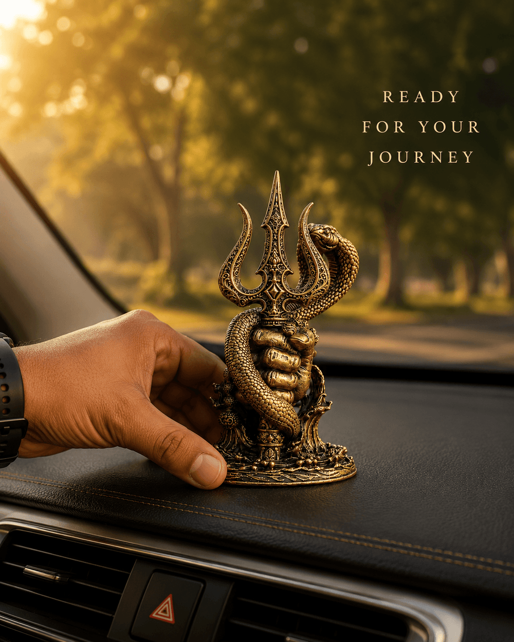 A hand placing the Nagadhari Mahadev Trishul idol on a car dashboard
