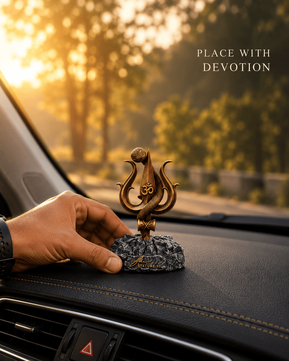 A hand placing the Shiv Trishul idol on a car dashboard
