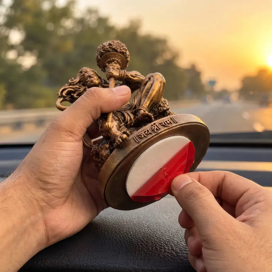Peeling the liner off the double-sided tape under the Mahabali Hanuman idol's base