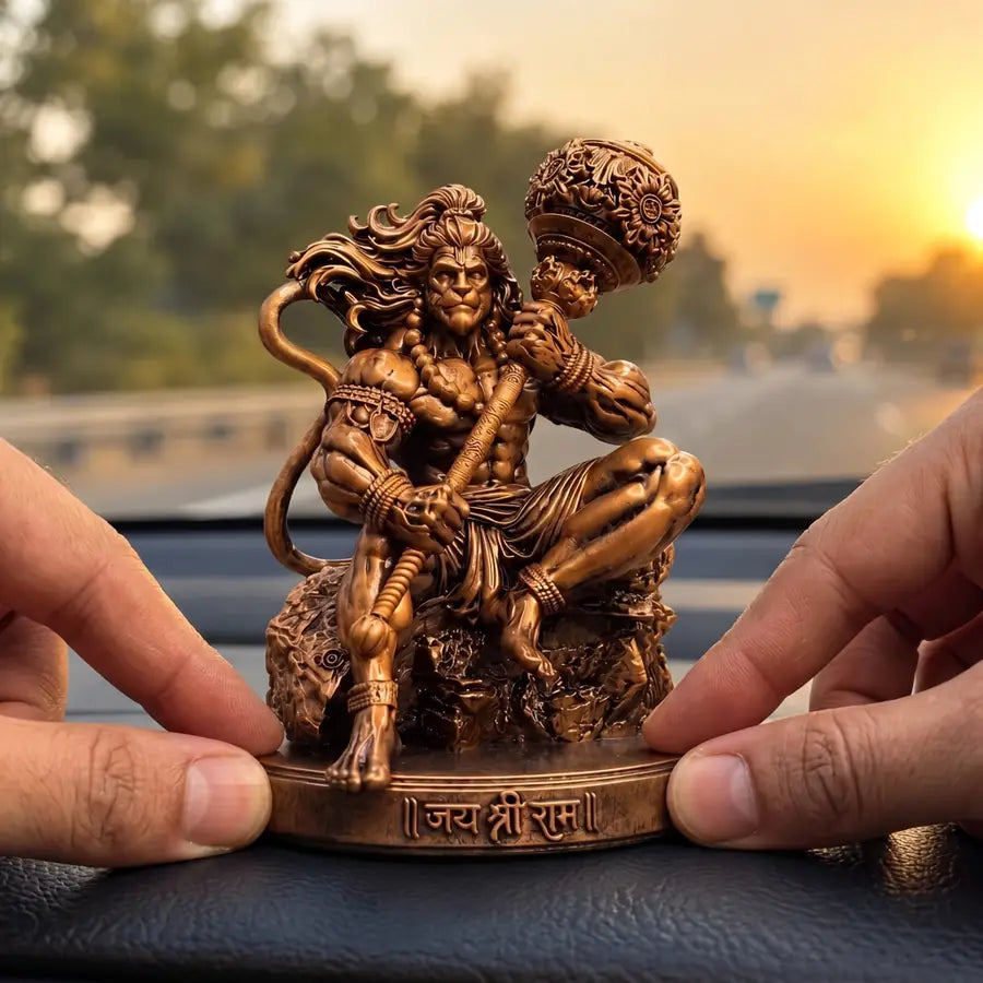 Pressing the Mahabali Hanuman idol firmly onto the car dashboard